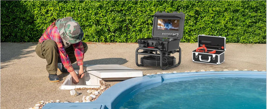 Waterproof sewer inspection camera being used outdoors near water